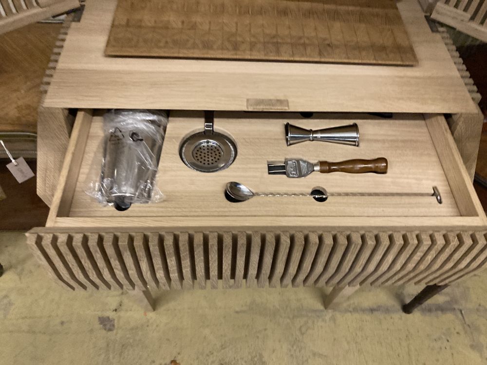 A Christopher Coane design British oak spirits cabinet, supplied with British spirits glassware and stainless steel accessories, width